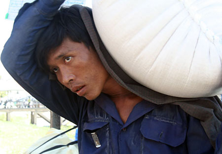 53 Portrait of man with bag of rice