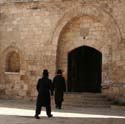 22 Hasadic Jews walking into temple, Jerusalem