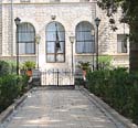 34 Nun in doorway dressed in white, Church of the Beatitudes, Israel