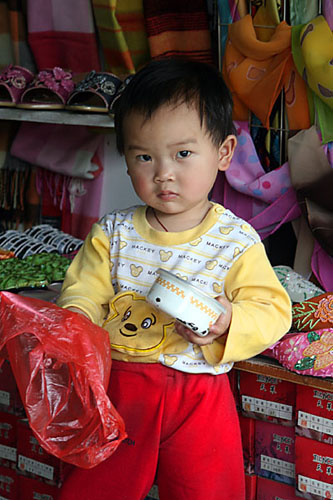 09 Little boy standing in shop